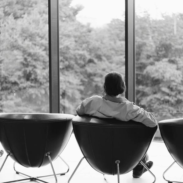 Person sitting comfortably in a well-lit modern office space.